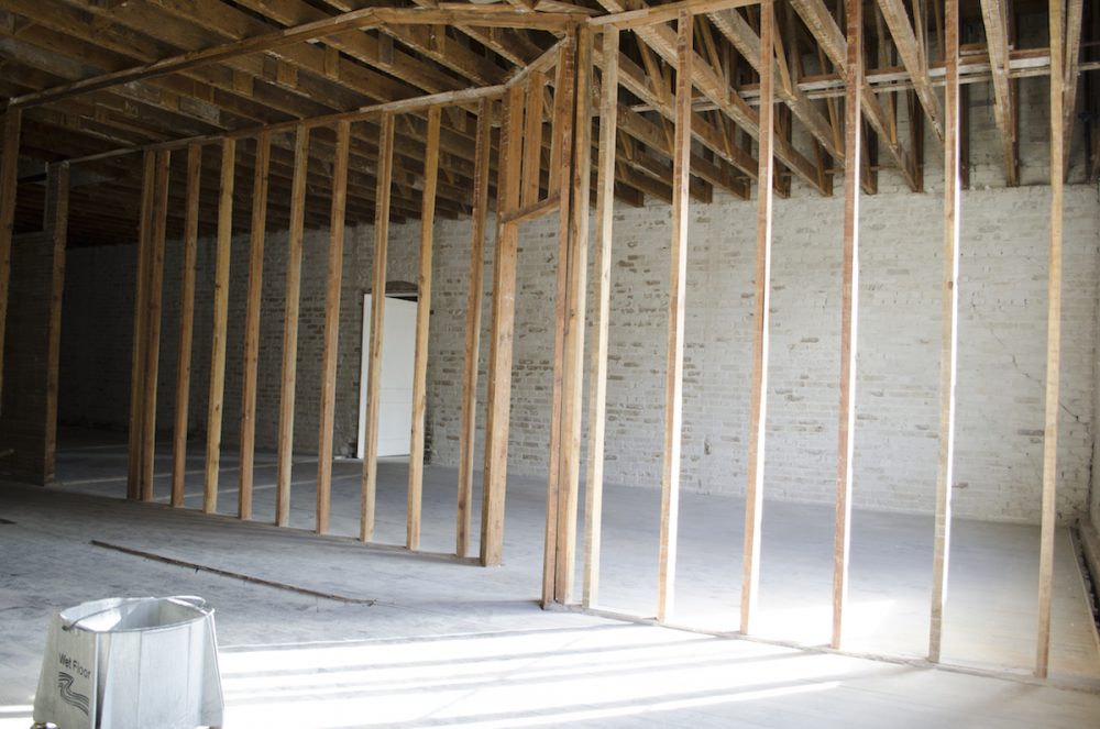 Original 1920s brick walls and hardwood floors are being fully restored.